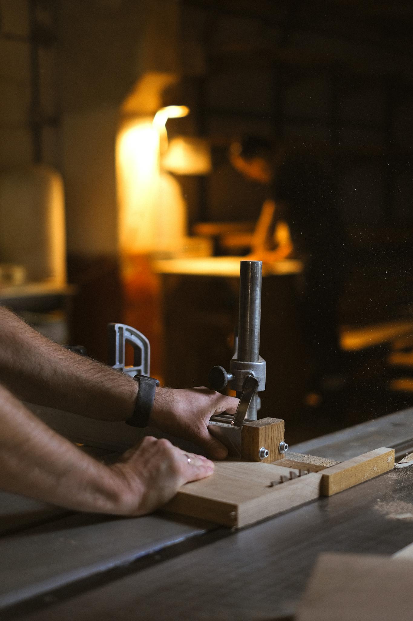 Crop artisan cutting wood with table saw